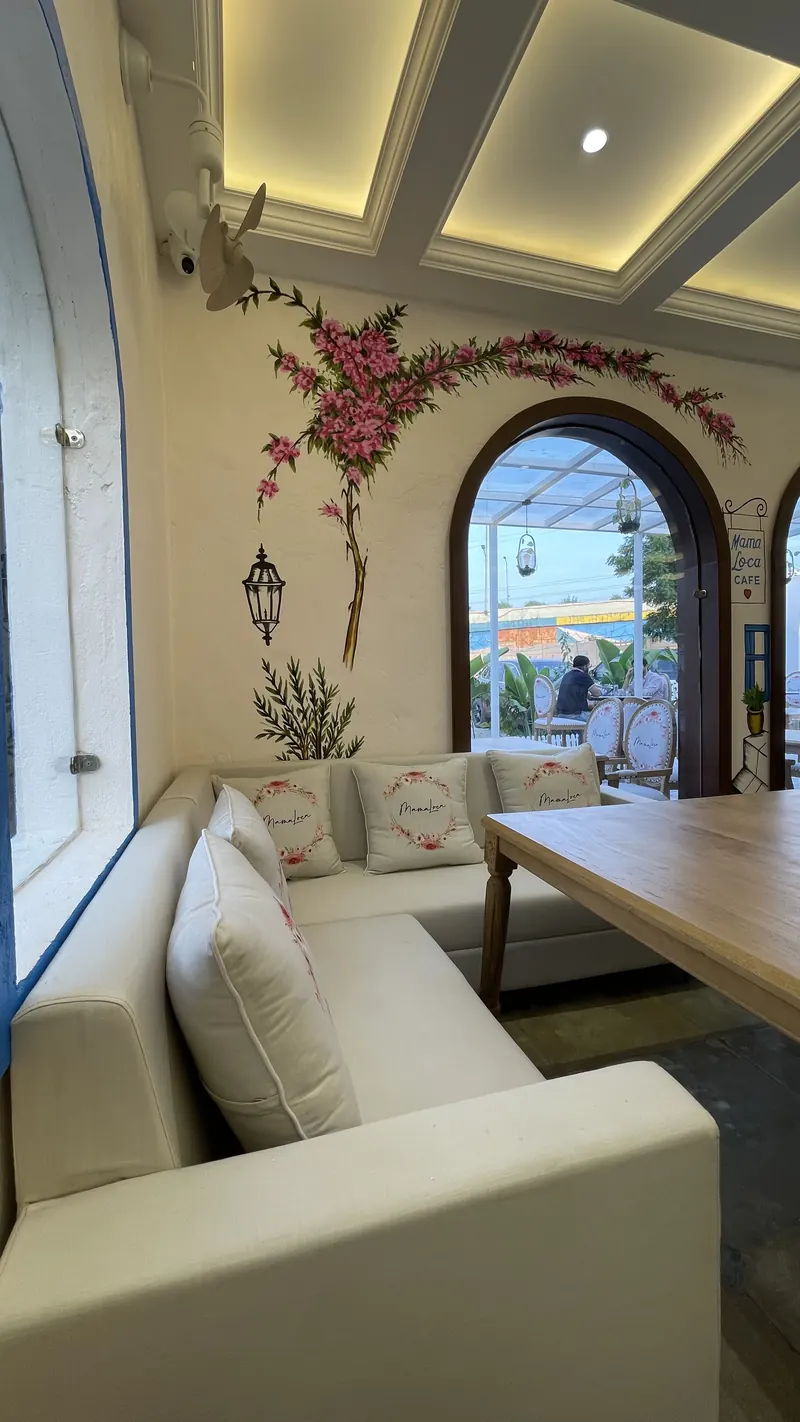 A corner banquette under a painted bougainvillea vine