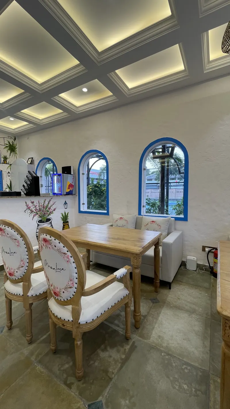 Blue-framed arched windows along the dining room wall