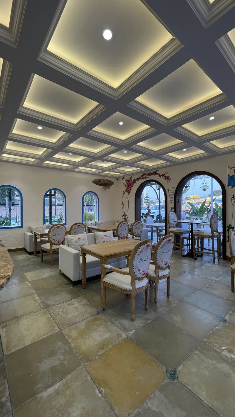 The dining room, with daylight coming through blue-framed arches