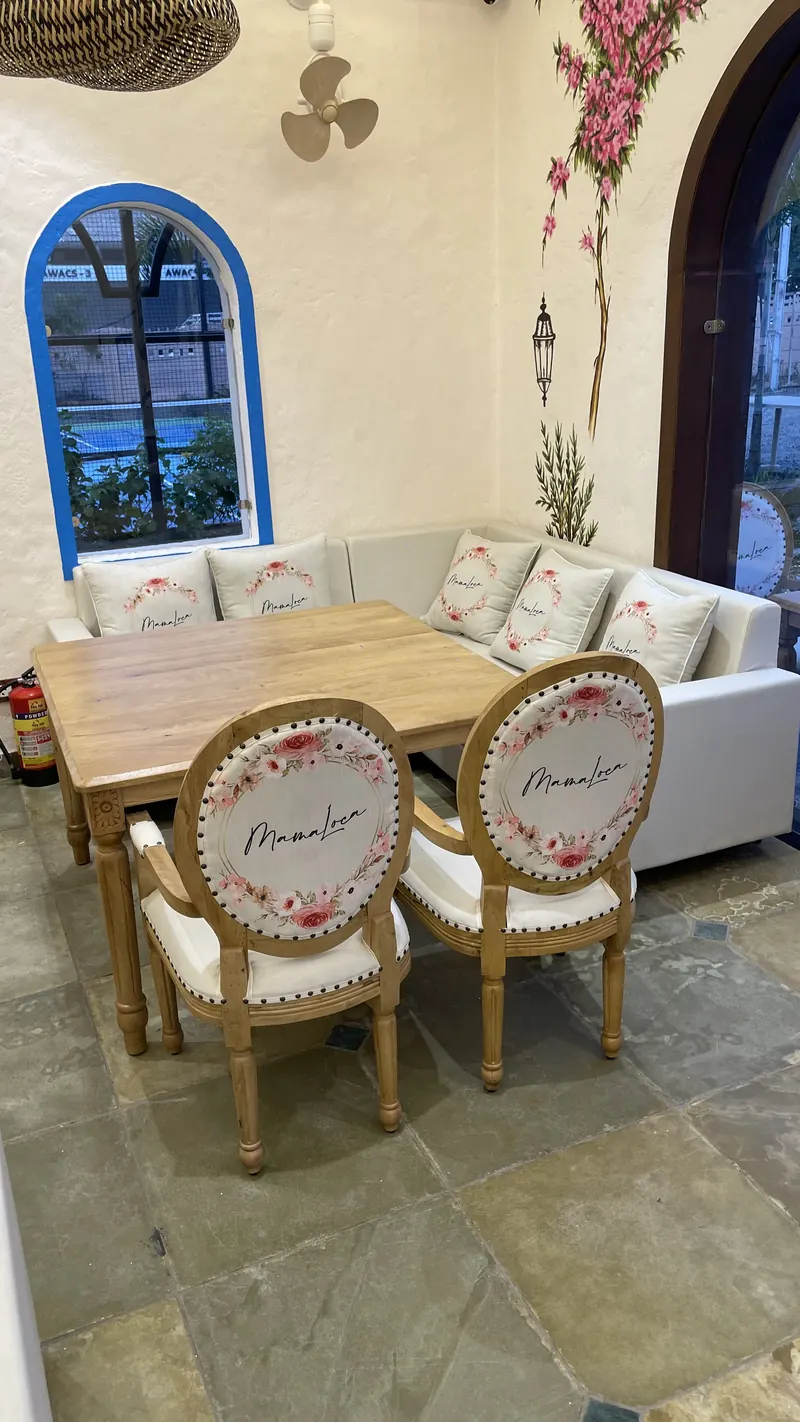 A table for four in daylight, beside a blue arched window