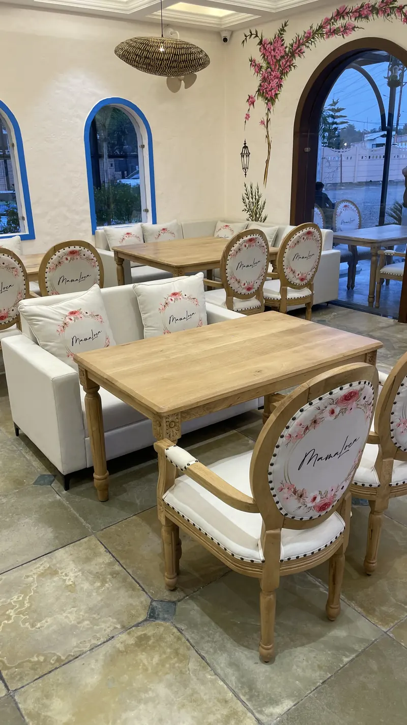 Tables in the dining room, under painted bougainvillea