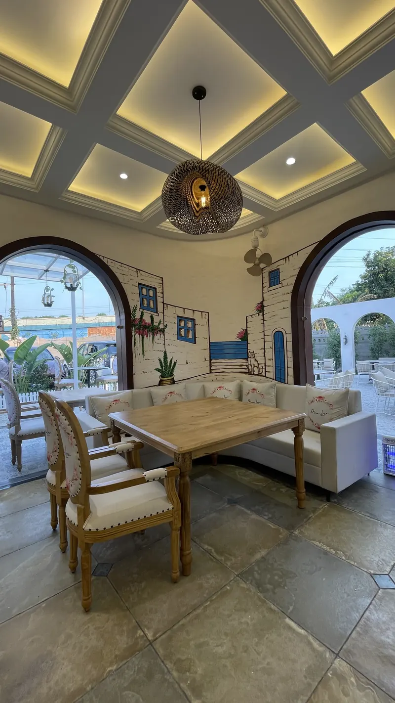 Banquette seating under the arched windows of the hall