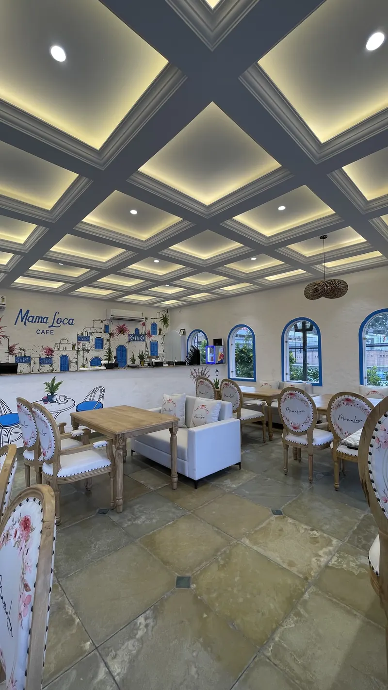 The dining hall seen wide, with the mural wall behind the counter