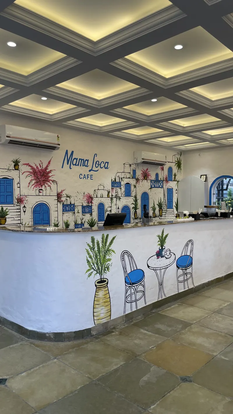 The curved counter under the hand-painted Mama Loca Cafe mural
