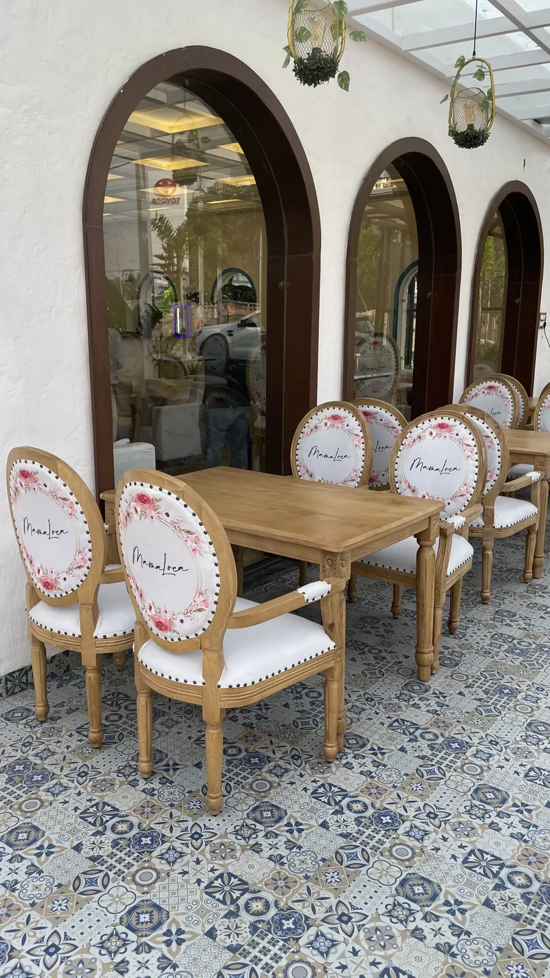 Oval-back chairs with the Mama Loca wreath, along the pergola arcade